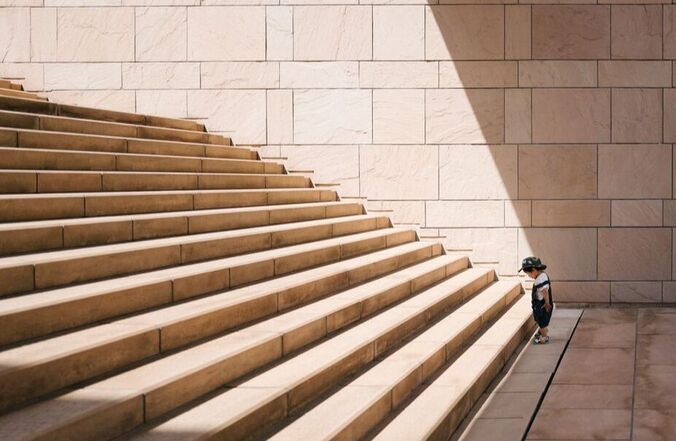 child looking at stairs ahead getting motivated
